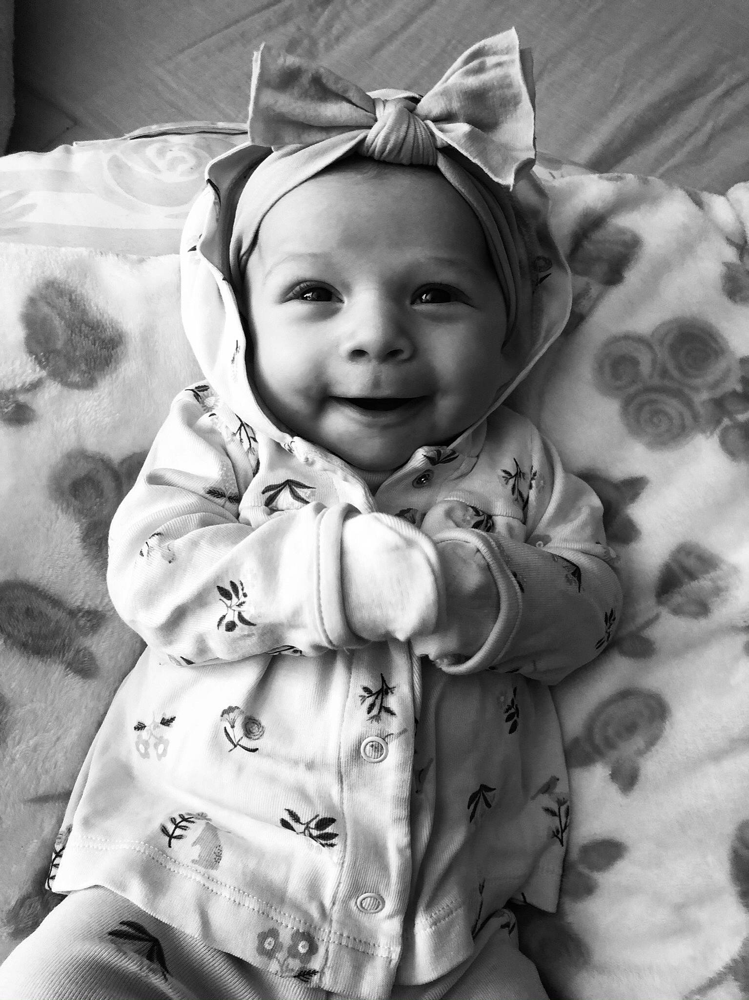 Aurelia is registered to the contest to win money with this photo: baby, baby_toddler_clothing, black_and_white, cheek, child, comfort, eye, flash_photography, gesture, happy, headwear, joy, linens, monochrome, monochrome_photography, person, room, sleeve, smile, stock_photography