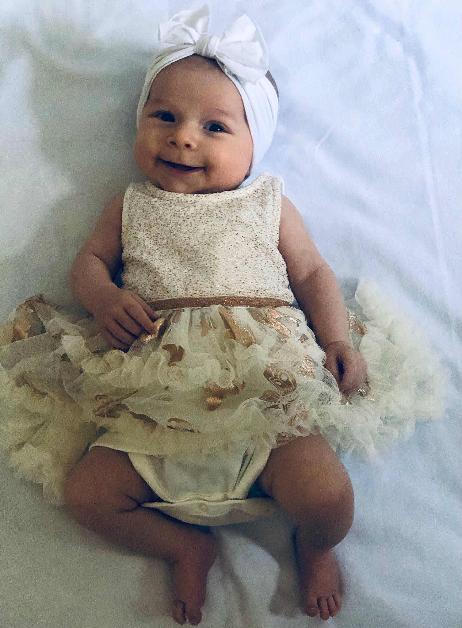 Aurelia is registered to the contest to win money with this photo: baby, baby_toddler_clothing, child, day_dress, dress, embellishment, eye, flash_photography, happy, headpiece, headwear, human_body, iris, joy, person, photograph, pink, skin, sleeve, smile