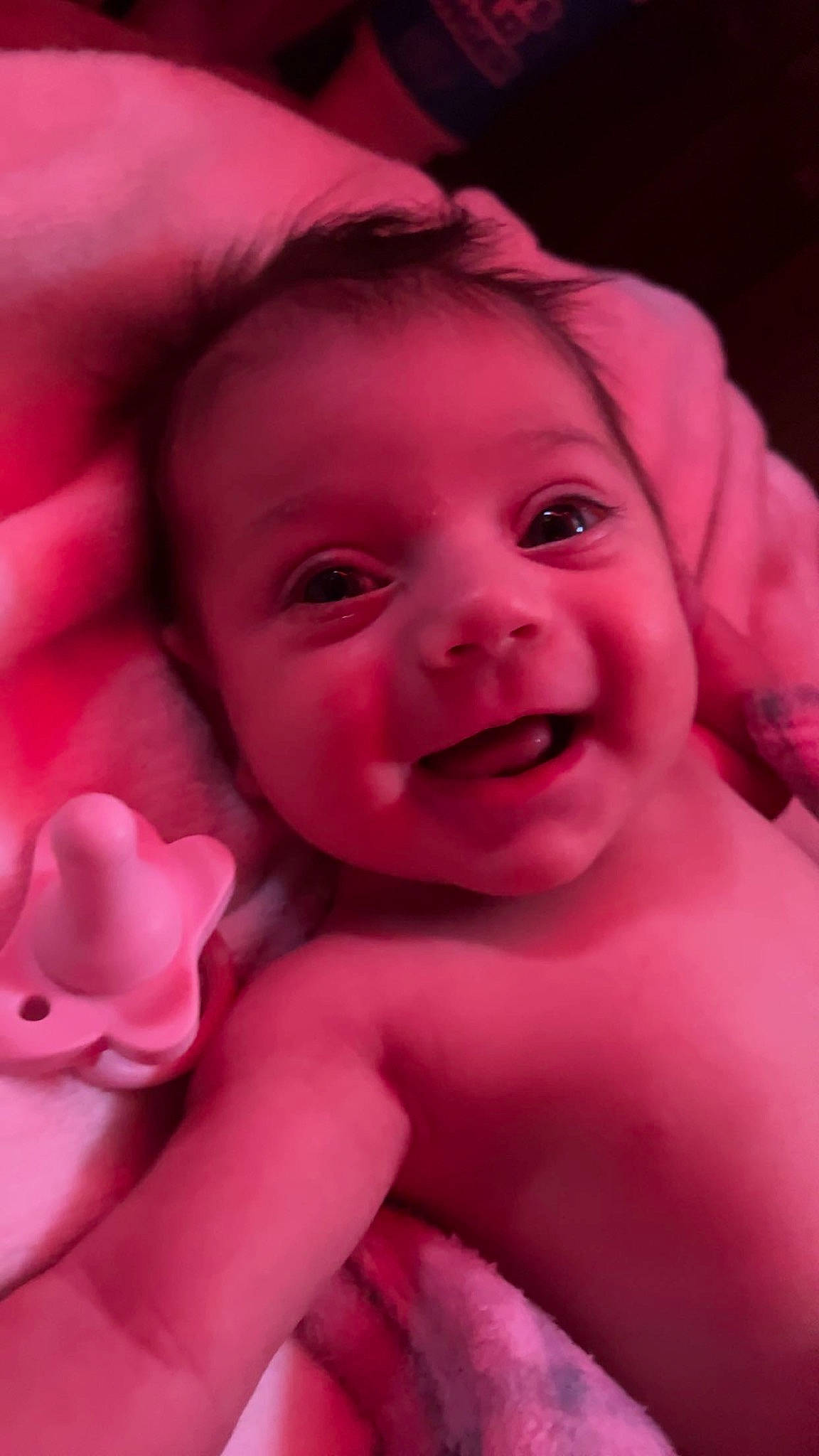 Athena is registered to the contest to win money with this photo: baby, cheek, chin, eye, eyebrow, face, finger, flash_photography, gesture, happy, head, human_body, iris, joy, lip, mouth, nose, person, pink, purple