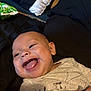 baby, blanket, child, clothing, cute, expression, face, happy, head, indoor, infant, joy, lying_down, mouth_open, onesie, person, pillow, skin, smiling, young