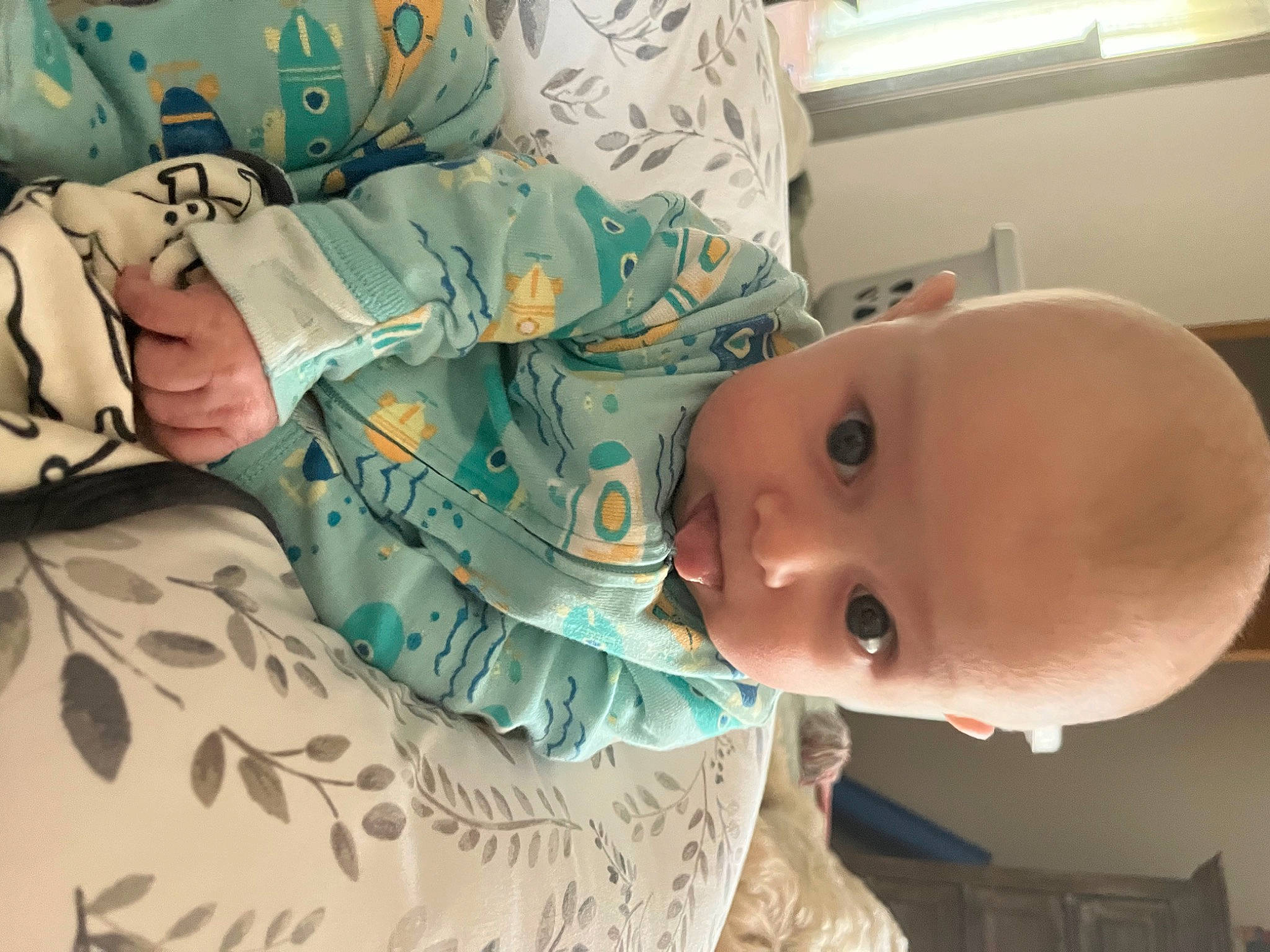 Andy is registered to the contest to win money with this photo: baby, baby_products, baby_safety, baby_toddler_clothing, bedding, bedtime, cheek, child, comfort, linens, pattern, person, room, skin, sleeve, smile, textile, toddler, window