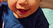Emory is registered to the contest to win money with this photo: toddler, child, blue_hat, blue_shirt, smiling, hand, patterned_rail, indoor, playpen, baby, cute, happy, face, portrait, young_child, person, clothing, socks, colorful, grip