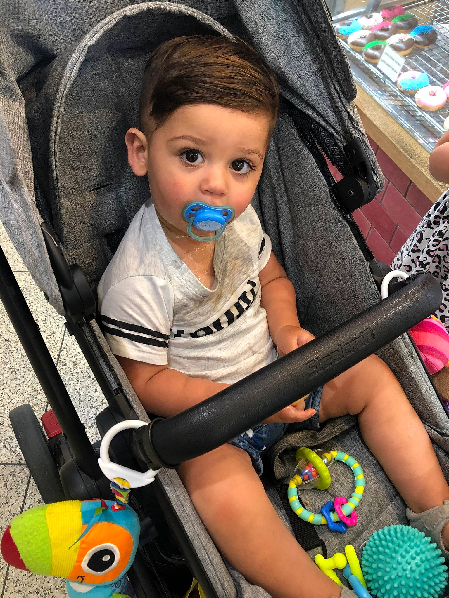 Krish is registered to the contest to win money with this photo: baby_carriage, baby_products, black_hair, car_seat, child, eye, leg, person, play, product, sitting, skin, surprise, toddler, vacation