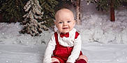 Landon is registered to the contest to win money with this photo: baby, child, snow, winter, holiday, pine_tree, red_clothing, bow_tie, suspenders, smile, sitting, snowfall, festive, cute, portrait, indoor, studio, white_background, frosted_trees, warm_clothing