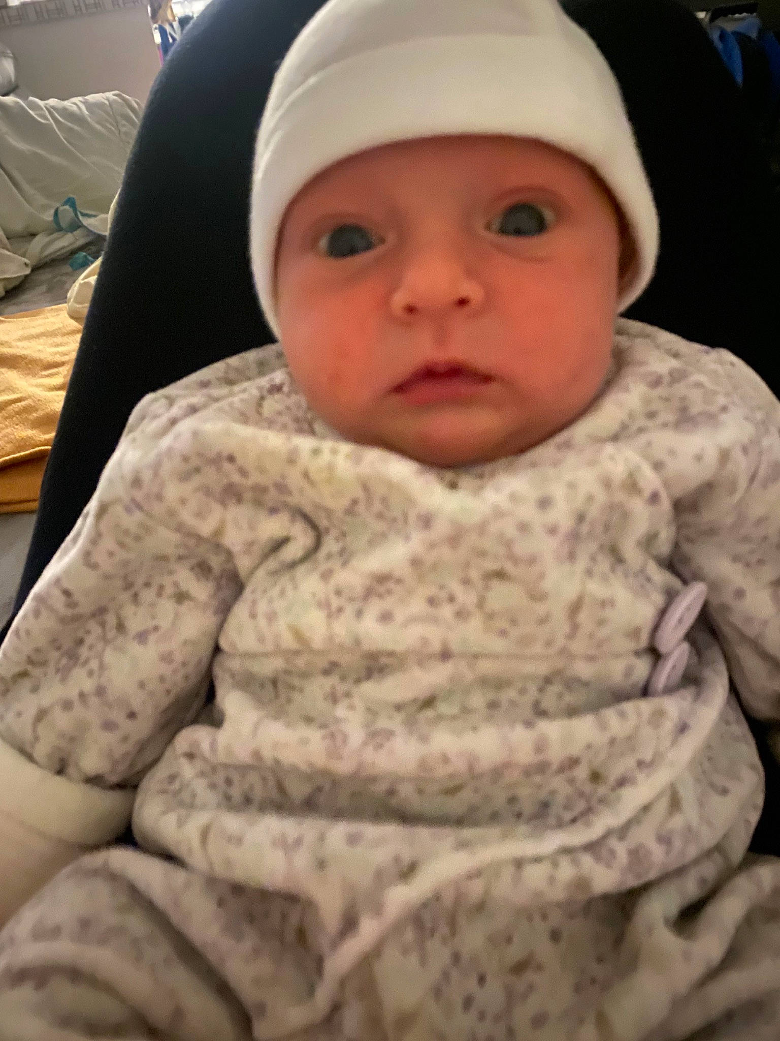 Amëlya participe au concours pour gagner de l'argent avec cette photo : baby, baby_toddler_clothing, cap, cheek, child, chin, comfort, eye, eyebrow, face, facial_expression, headgear, headwear, iris, linens, lip, mouth, nose, person, skin