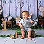 Enea participe au concours pour gagner de l'argent avec cette photo : baby, barefoot, bear, child, crate, deer, floor, forest_backdrop, fox, green_cloth, illustrated_animals, mushrooms, owl, portrait, raccoon, smile, squirrel, striped_overalls, toddler, wooden_toy