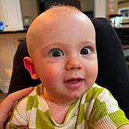 Zephaniah joined the competition — help win amazing prizes! baby, child, face, wide_eyes, curious, hand, indoor, person, shirt, green, white, checkered, skin, head, expression, close_up, portrait, young, caucasian, smile