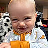 Zephaniah joined the competition — help win amazing prizes! baby, child, smiling, pajamas, face, head, expression, indoor, cozy, blanket, hand, cuteness, person, infant, cheeky, happy, young, cute, portrait, funny