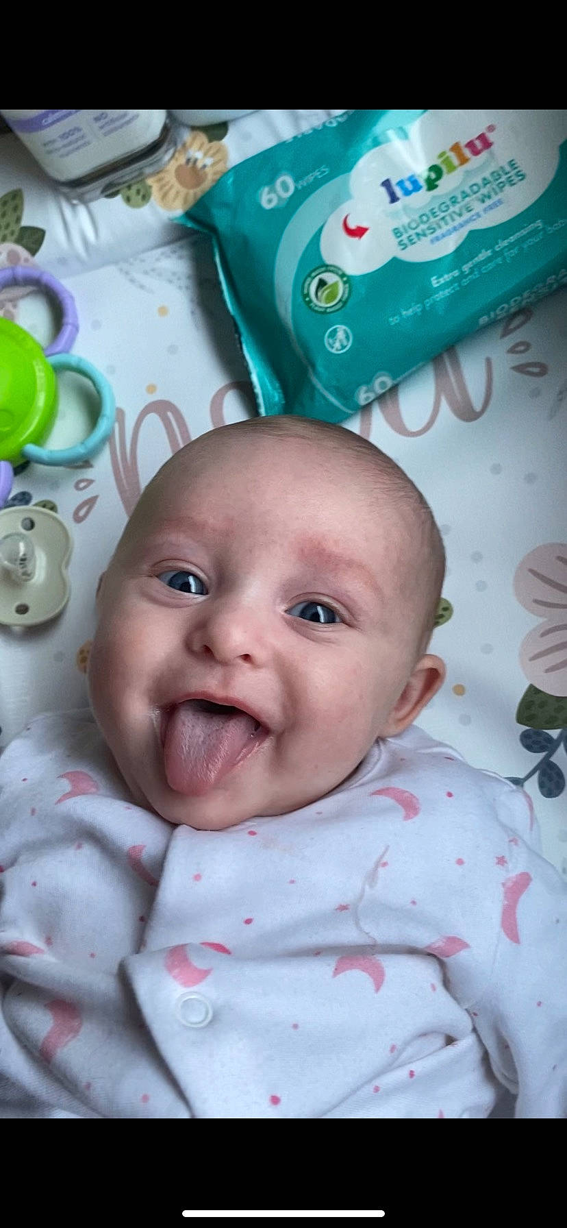 Nova is registered to the contest to win money with this photo: baby, baby_products, baby_toddler_clothing, cheek, child, green, happy, linens, person, pink, plastic, skin, smile, textile, toddler