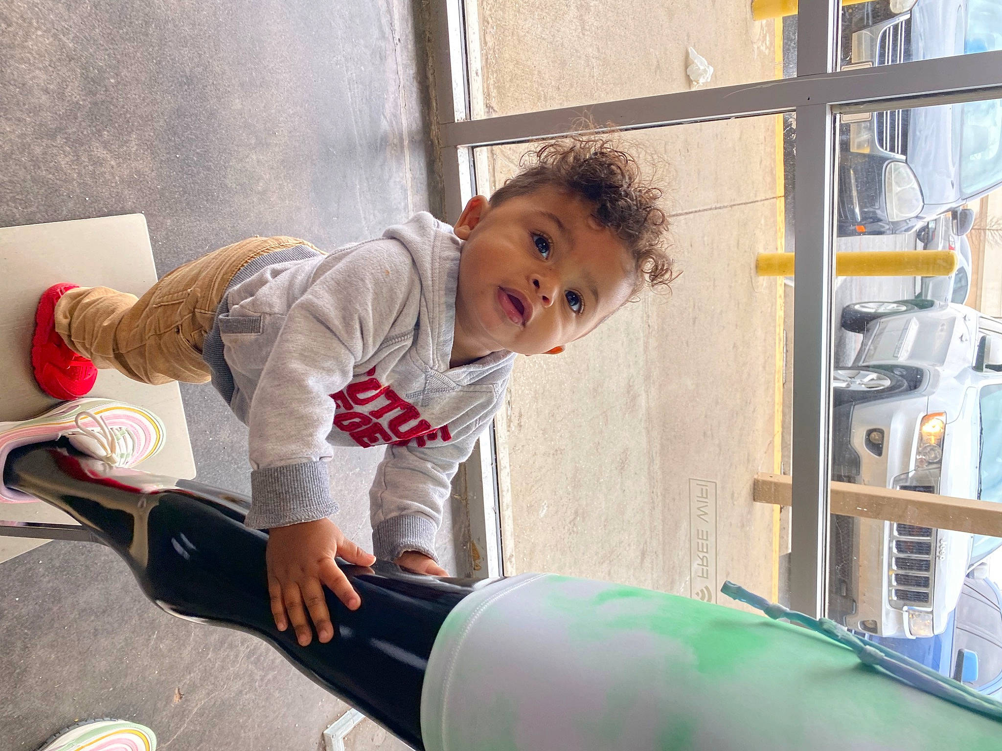 Huxley is registered to the contest to win money with this photo: baby, baby_toddler_clothing, child, comfort, flooring, fun, gas, happy, human_leg, knee, leisure, machine, person, play, room, sitting, sleeve, sock, t_shirt, toddler