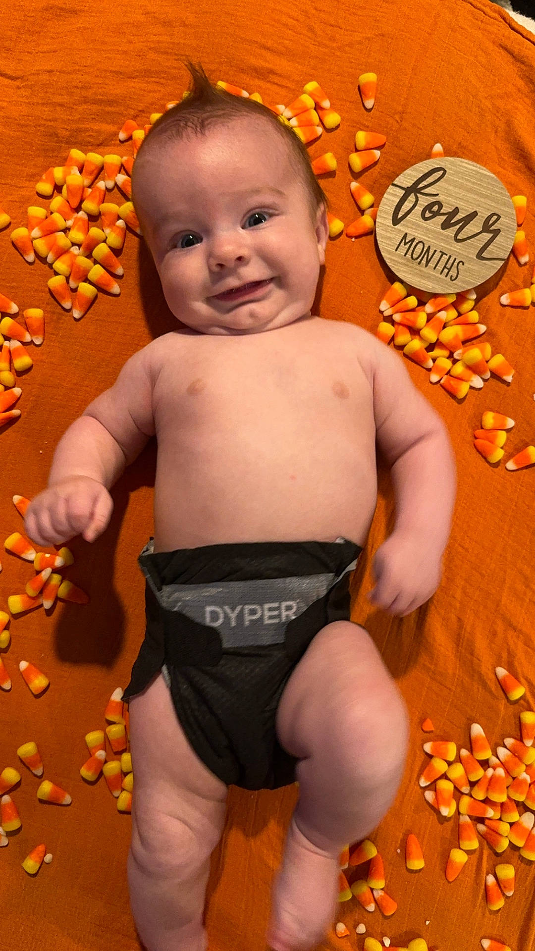 Huxlee is registered to the contest to win money with this photo: baby, bodypart, candy, clothing, corn, diaper, face, finger, food, fruit, hand, head, newborn, person, photography, plant, portrait, produce, shorts, sweets