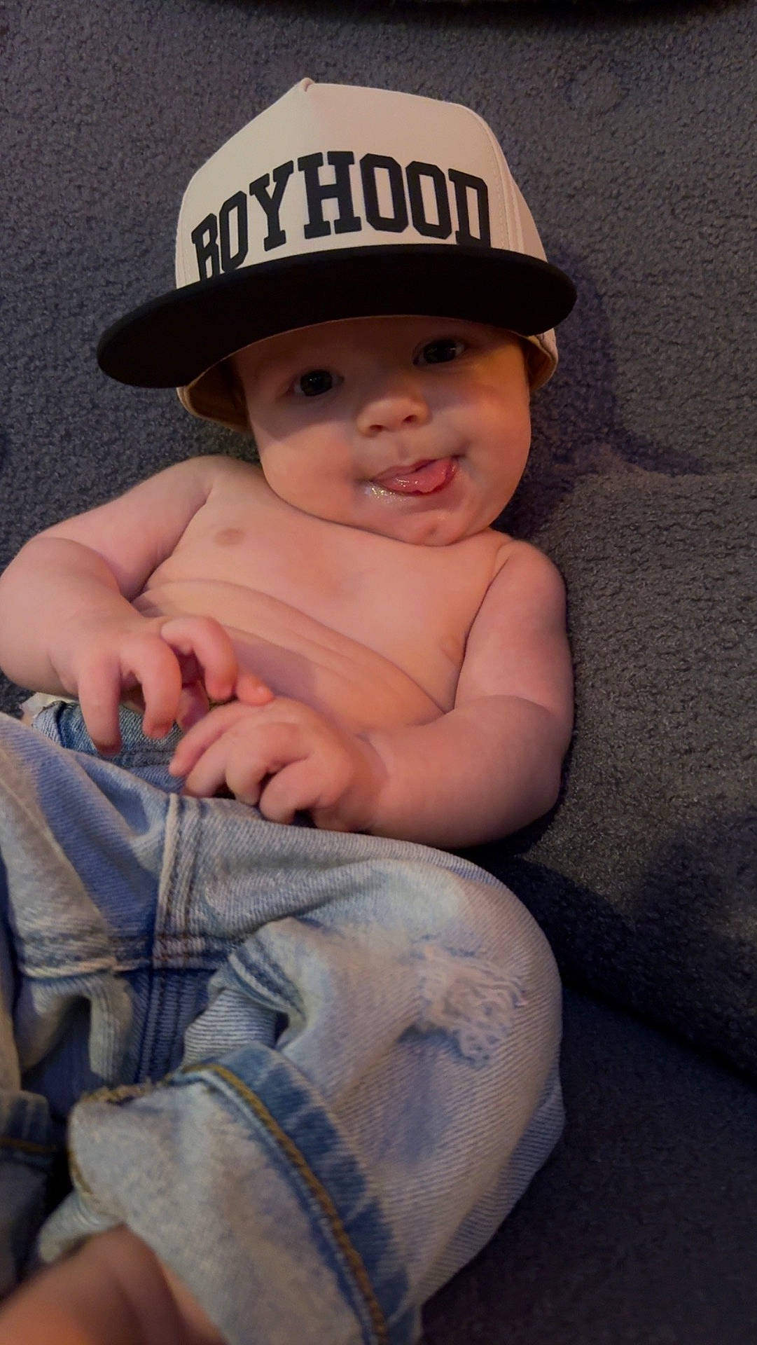 Huxlee joined the competition — help win amazing prizes! baby, baseballcap, bodypart, bonnet, cap, clothing, couch, face, finger, furniture, hand, hat, head, jeans, newborn, pants, person, photography, portrait, sunhat