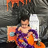 Zaydin is registered to the contest to win money with this photo: accessories, baby, clothing, costume, face, festival, flower, flowerarrangement, food, halloween, head, ornament, person, photography, plant, portrait, produce, pumpkin, purple, vegetable