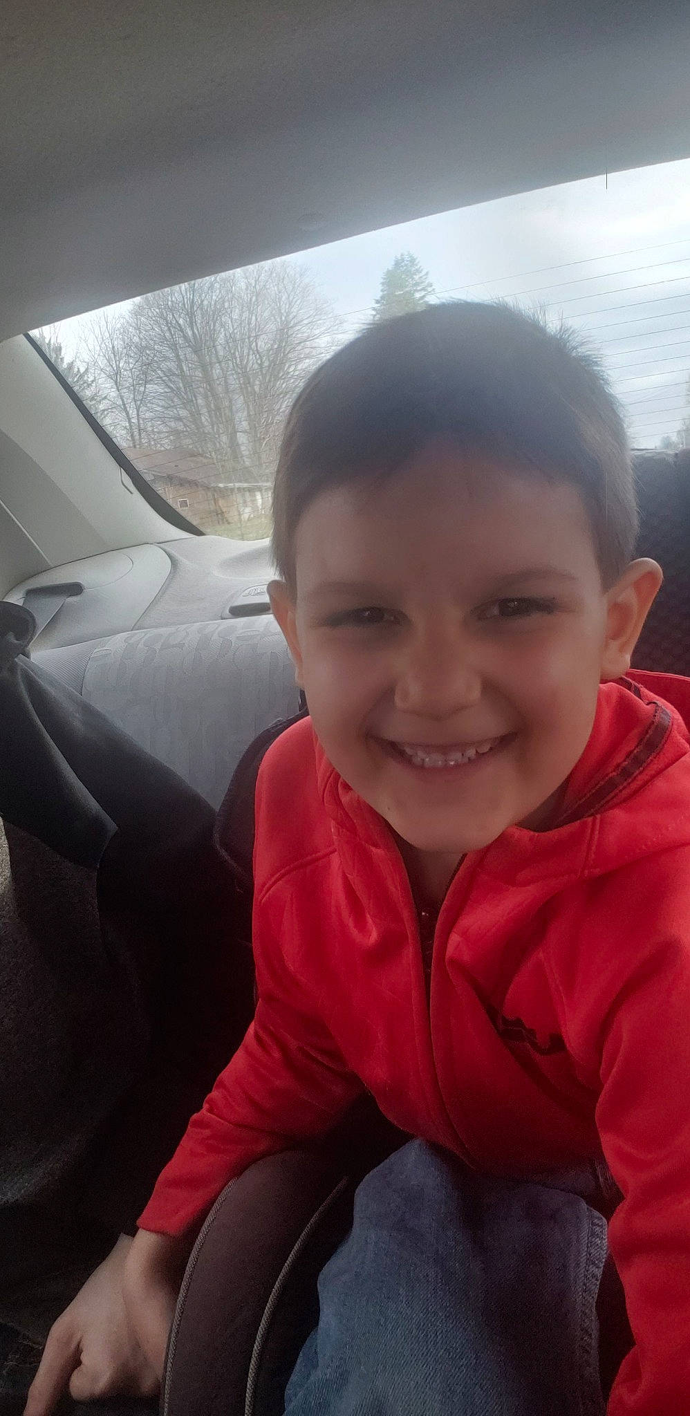 Michael is registered to the contest to win money with this photo: black_hair, car, cheek, child, cool, face, facial_expression, family_car, forehead, happy, head, joy, mouth, nose, person, photography, selfie, skin, smile