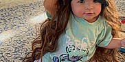 Jaylannie is registered to the contest to win money with this photo: bookshelf, carpet, child, clothing, curious, cute, floor, furniture, hair, indoor, living_room, pajamas, patterned_rug, person, playful, sleep_mask, smile, toddler, toy, wig