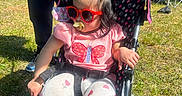 Jaylannie joined the competition — help win amazing prizes! butterfly, casual, child, daytime, event, fashion, grass, heart_pattern, outdoor, pacifier, people, person, pink_clothing, seat, shoes, stroller, sunglasses, sunny, tent, toddler