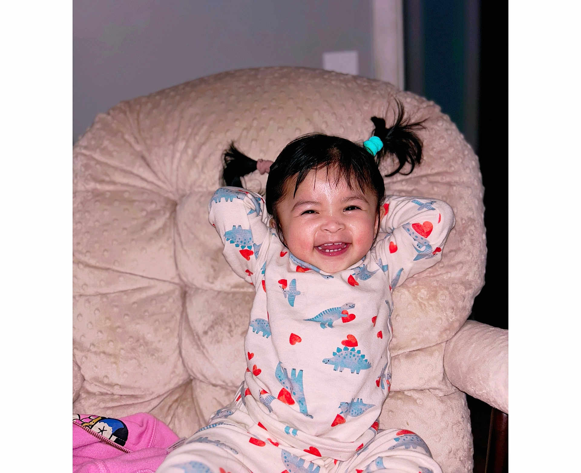 Jaylannie joined the competition — help win amazing prizes! toddler, child, pajamas, dinosaur_print, heart_pattern, smiling, happy, pigtails, chair, plush_chair, indoor, cute, person, baby, portrait, playful, cozy, clothing, young_child, seated