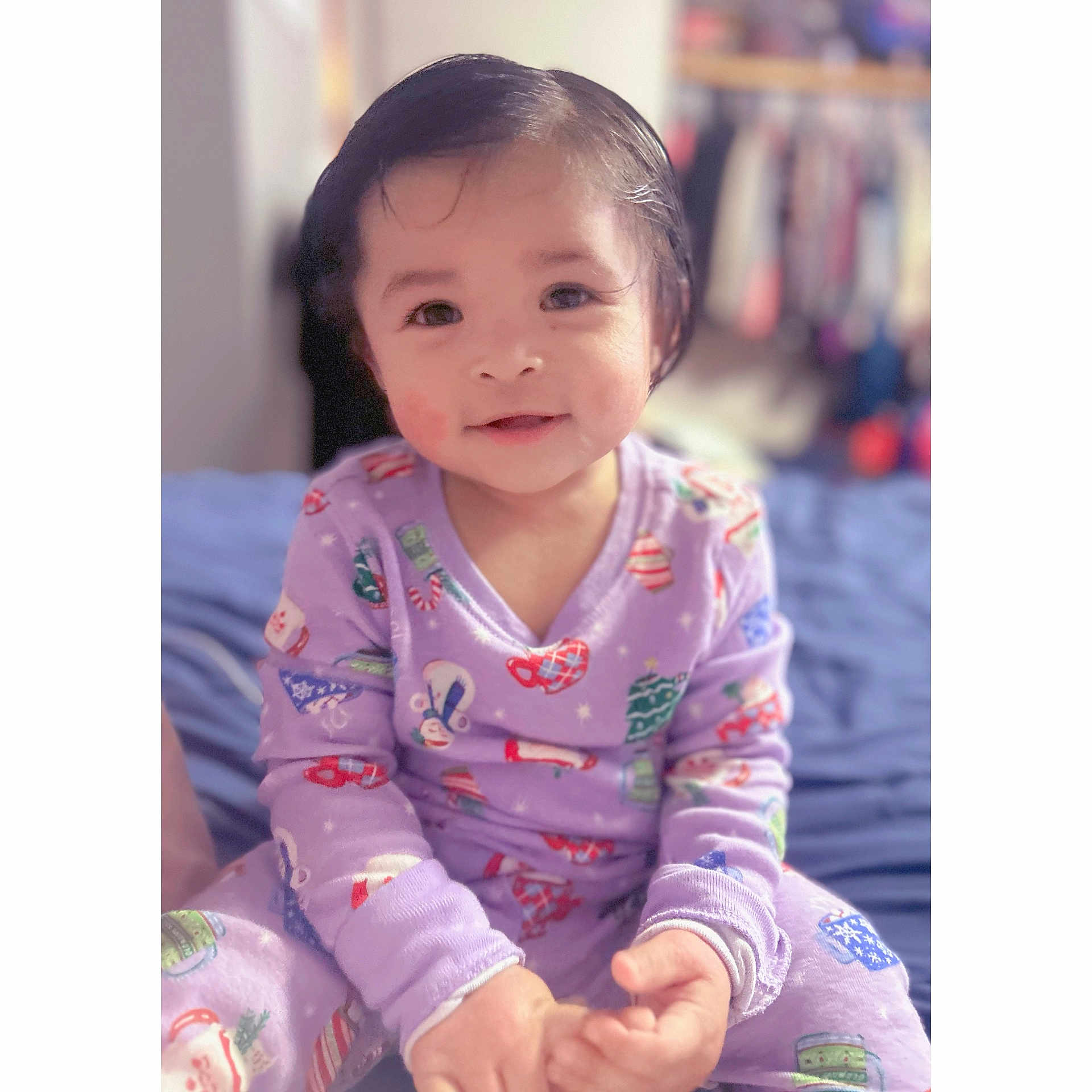 Jaylannie joined the competition — help win amazing prizes! toddler, child, pajamas, purple, smiling, bedroom, bed, holiday_theme, face, hands, sitting, indoors, cute, young_child, person, clothing, soft_lighting, portrait, happy, cozy