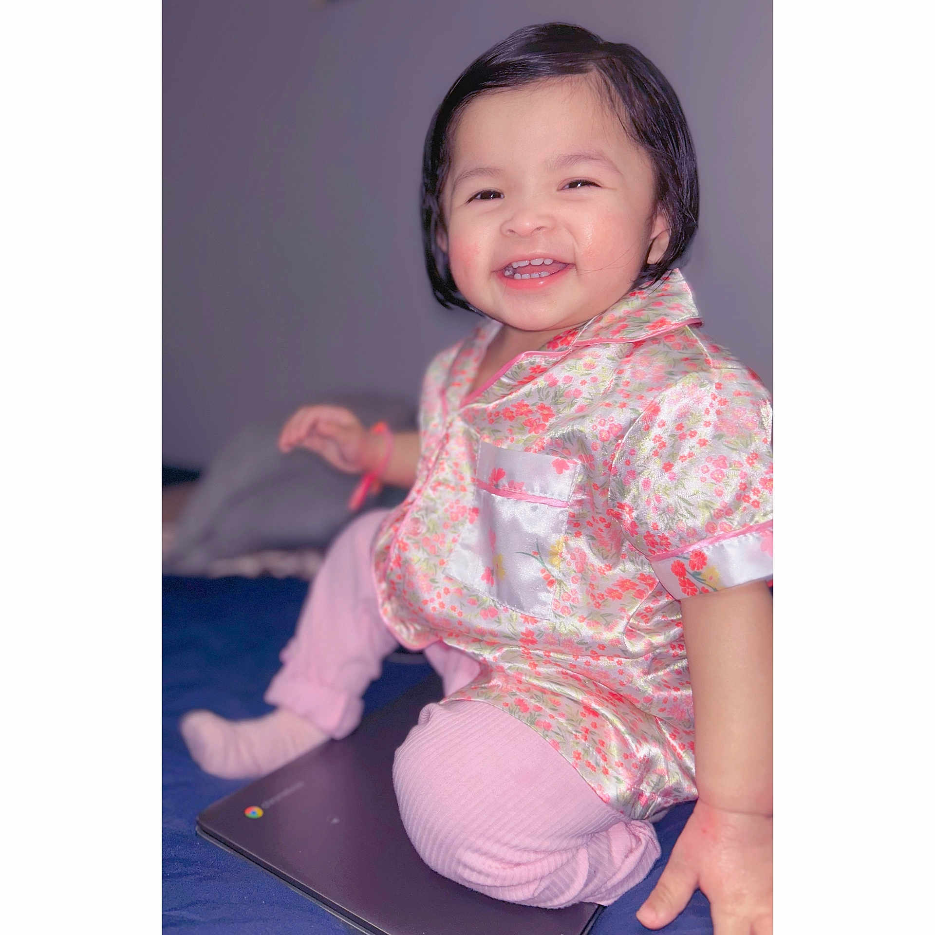 Jaylannie is registered to the contest to win money with this photo: toddler, child, smiling, happy, indoor, pajamas, floral_pattern, laptop, sitting, cute, young_child, face, person, clothing, pink, portrait, baby, fun, joy, skin