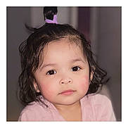 Jaylannie is registered to the contest to win money with this photo: child, toddler, portrait, face, eyes, cheeks, hair, ponytail, pink_clothing, skin, indoors, close_up, cute, soft_lighting, baby_hair, neutral_expression, curly_hair, blush, innocence, headshot