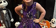 Robyn joined the competition — help win amazing prizes! child, face_paint, purple_dress, halloween, ghost_decorations, skull_lights, plush_toy, carpet, smiling, pose, indoor, decorations, black_shoes, happy, festive, toy, costume, playful, home, celebration