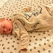 Eleanor is registered to the contest to win money with this photo: baby, newborn, sleeping_baby, onesie, crib_sheet, floral_pattern, nursery, cozy, peaceful, closed_eyes, infant, head, ear, arm, hand, leg, foot, soft_lighting, indoor, fabric