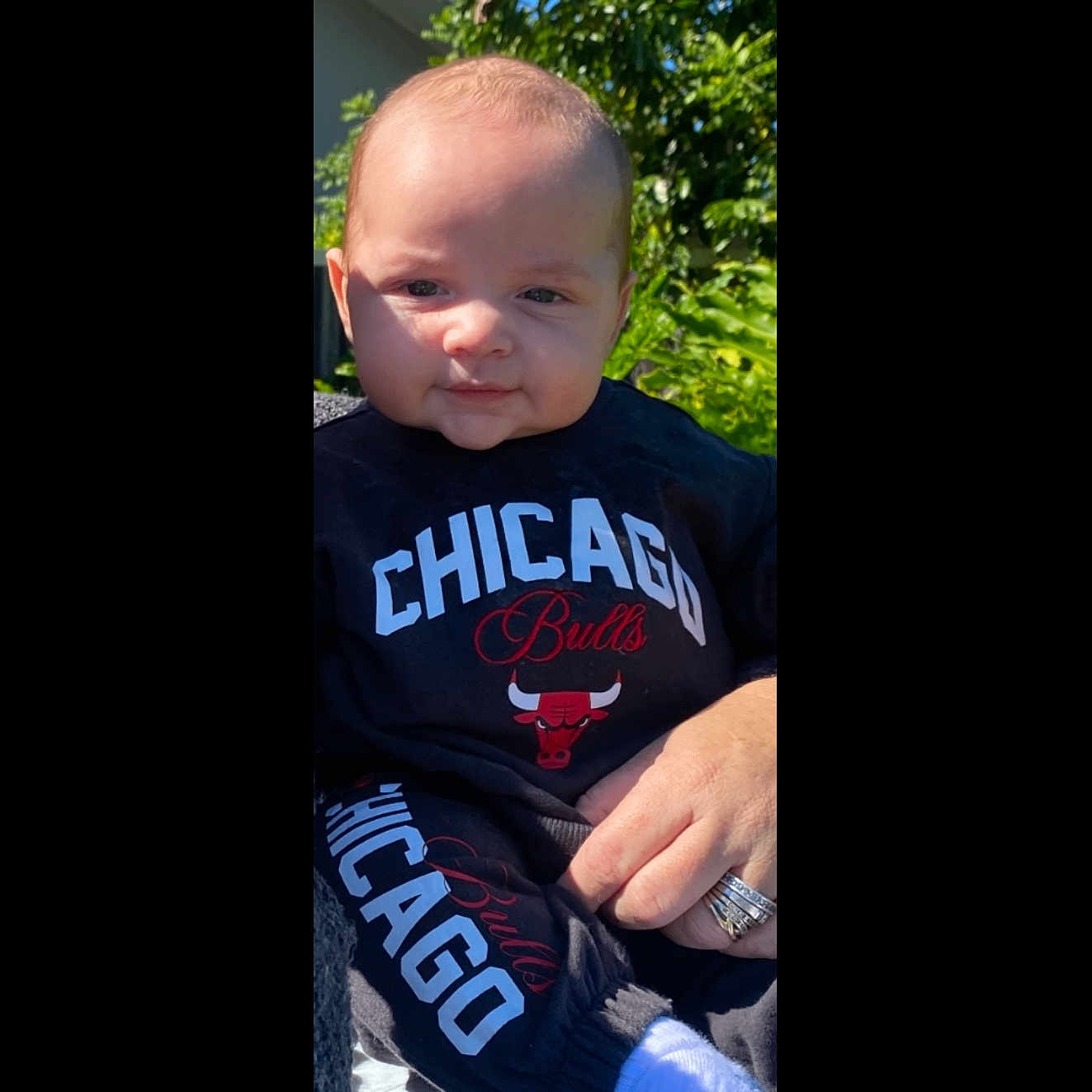 Kaizaya joined the competition — help win amazing prizes! baby, black_clothing, casual_wear, child, clothing, cute, expression, face, greenery, hand, logo, nature, outdoor, person, portrait, ring, sitting, sportswear, sunlight, young_child