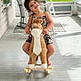 child, smiling, toy, rocking_horse, porch, wooden_floor, rocking_chair, happy, curly_hair, casual_clothing, play, indoor, daylight, barefoot, cute, fun, leisure, person, childhood, plush_toy