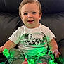 Jace joined the competition — help win amazing prizes! baby, child, smiling, happy, shirt, pants, feet, hands, string_lights, green_lights, shamrock, couch, leather, indoor, portrait, cute, playful, sitting, face, person