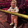 Jace joined the competition — help win amazing prizes! toddler, child, smiling, standing, bow_tie, white_shirt, pink_pants, white_shoes, theater, maroon_seats, carpet, railing, adult, supporting, indoor, person, happy, curly_hair, fashion, portrait