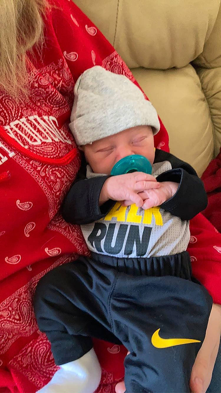 Phillip is registered to the contest to win money with this photo: baby, baby_products, baby_sleeping, baby_toddler_clothing, carmine, child, christmas, comfort, event, fictional_character, happy, headwear, holiday, lap, linens, pattern, person, red, sitting, sleeve