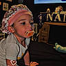 toddler, pacifier, bonnet, child, crawling, indoor, furniture, television, blurred_background, timestamp, clothing, person, baby, headwear, hand, face, expression, night, room, floor