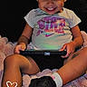 toddler, child, smiling, pink_bow, tablet, blanket, black_shoes, white_socks, shorts, tshirt, indoors, happy, portrait, cute, playing, technology, cozy, young_child, sitting, digital_device