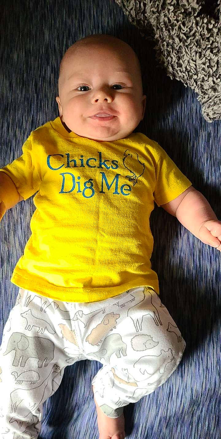 Ivan is registered to the contest to win money with this photo: arm, baby_toddler_clothing, black, cheek, chin, eye, face, facial_expression, hairstyle, hand, head, human, human_body, lip, muscle, nose, organ, outerwear, person, skin