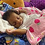 Amira is registered to the contest to win money with this photo: baby, sleeping, blanket, pink, strawberry_pattern, plush_toy, cozy, child, soft, cute, indoor, comfort, resting, infant, peaceful, colorful, bed, pillow, young_child, napping