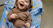 Mario joined the competition — help win amazing prizes! animal_print, appliance, baby, baby_chair, brown_clothing, casual, child, cute, expression, floor, happy, hoodie, indoor, infant, kitchen, person, playful, portrait, seat, smiling