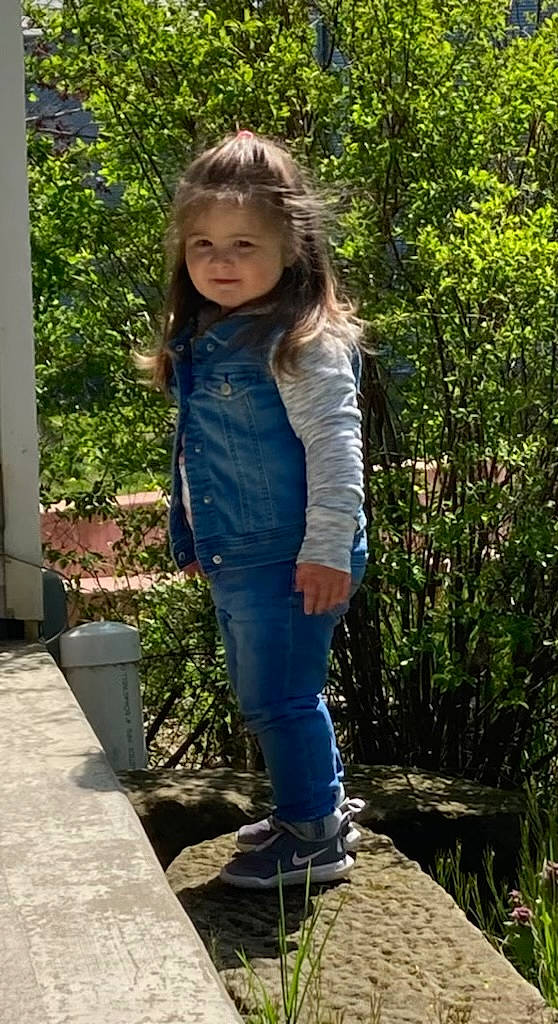 Adrian is registered to the contest to win money with this photo: boot, brown_hair, denim, electric_blue, fun, grass, jeans, knee, leisure, long_hair, pattern, person, plant, sleeve, sneakers, street_fashion, t_shirt, thigh, toddler, waist