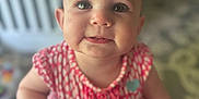 Nova is registered to the contest to win money with this photo: baby, child, infant, face, eyes, hands, clothing, pink, pattern, drool, indoor, blur, portrait, cute, young, person, skin, expression, holding, smile