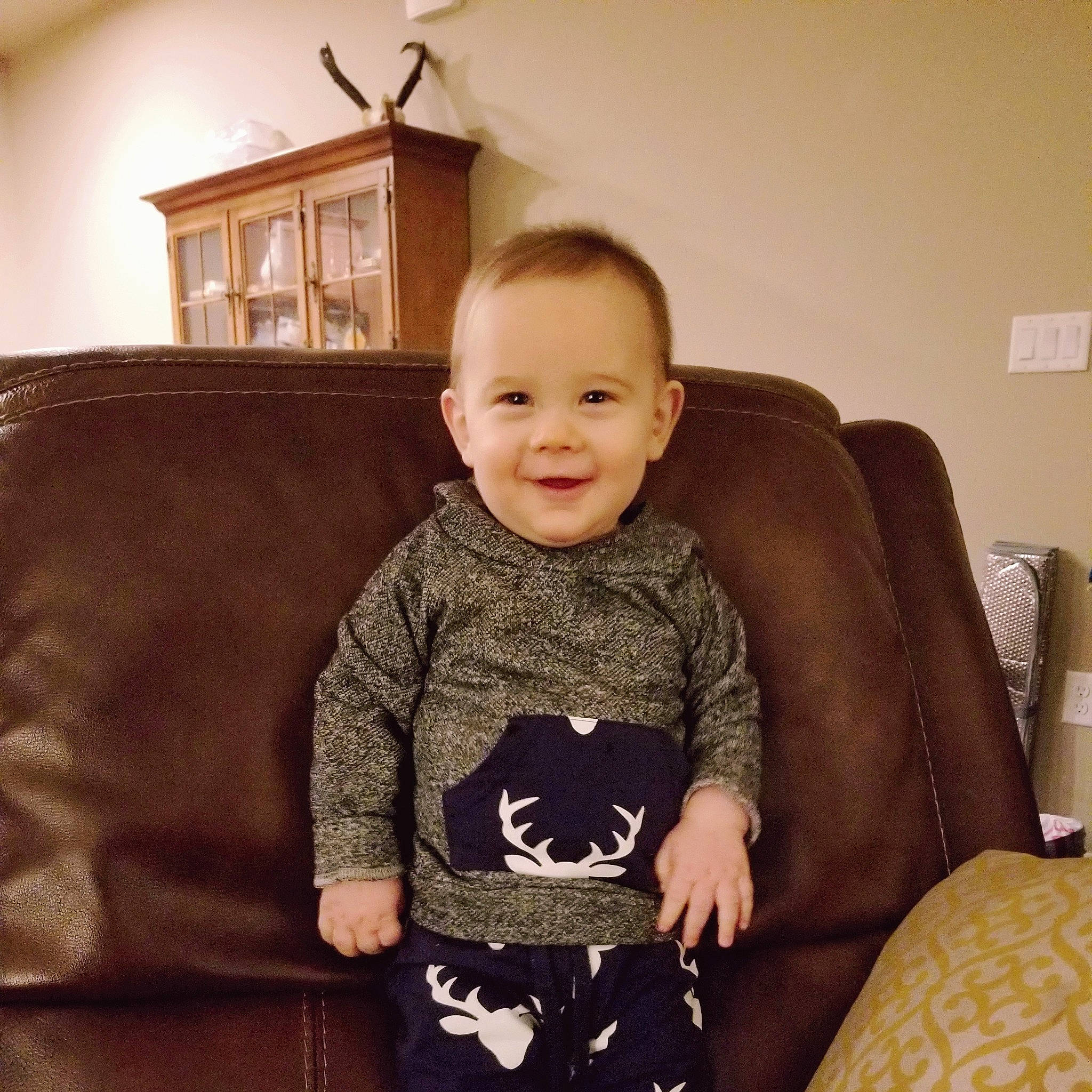 Knox is registered to the contest to win money with this photo: cheek, child, cool, couch, ear, eye, fawn, furniture, head, joy, person, sitting, sleeve, toddler