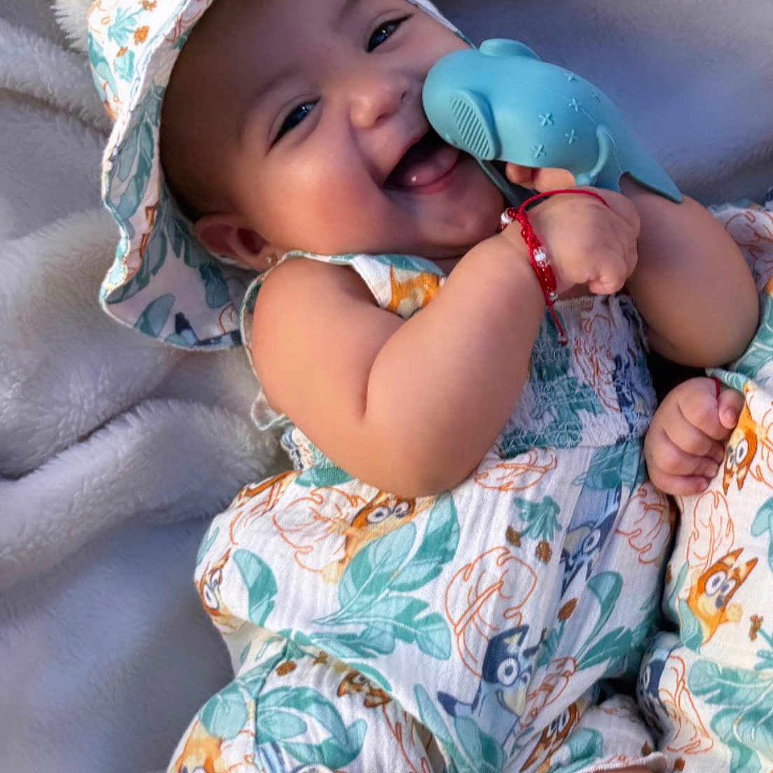 Valentina is registered to the contest to win money with this photo: arm, baby, blanket, cheerful, child, clothing, cute, happy, hat, infant, leg, patterned_outfit, playing, portrait, relaxing, skin, smile, soft_texture, toy, whale