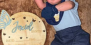Jexiel E. joined the competition — help win amazing prizes! baby, newborn, sleeping, blue_clothing, mittens, plush_blanket, wooden_plaque, name_sign, infant, cute, person, resting, portrait, soft_texture, toddler, indoor, cozy, child, peaceful, lying_down