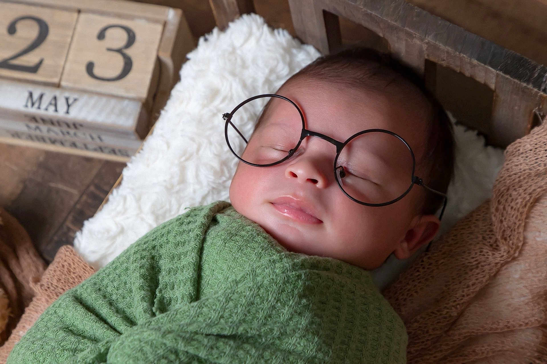 Jexiel E. joined the competition — help win amazing prizes! baby, sleeping, glasses, blanket, green_blanket, pillow, wooden_blocks, calendar, face, child, indoors, cozy, cute, portrait, rest, soft_texture, newborn, head, peaceful, person