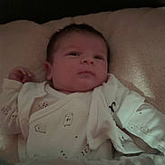 élias participe au concours pour gagner de l'argent avec cette photo : baby, bed, blanket, child, comfort, cute, dim_light, hedgehog_pattern, indoors, infant, lying_down, newborn, onesie, peaceful, portrait, resting, sleepwear, sleepy, small_hand, soft_texture