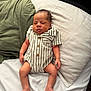 Waylon is registered to the contest to win money with this photo: baby, newborn, infant, sleeping, striped_clothing, onesie, pillow, bed, blanket, skin, foot, hand, face, peaceful, indoors, resting, soft_light, casual, cute, child