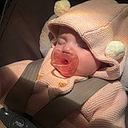 Amaia joined the competition — help win amazing prizes! baby, child, sleeping, car_seat, pacifier, knitted_clothing, hood, pom_poms, seatbelt, infant, cute, cozy, indoor, closeup, soft_light, pink, small_person, resting, transportation, safety