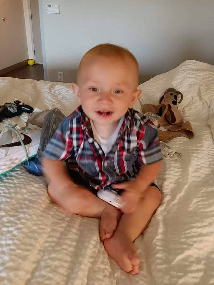 Huey is registered to the contest to win money with this photo: baby, baby_toddler_clothing, cheek, child, comfort, crawling, eye, floor, flooring, fun, happy, hardwood, human_body, human_leg, pattern, person, skin, sleeve, smile, toddler