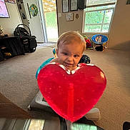 Matthew joined the competition — help win amazing prizes! baby_seat, candy, carpet, child, childcare, curious, daylight, floor, furniture, heart, home_decor, indoor, living_room, lollipop, person, playful, smile, toddler, toy, window