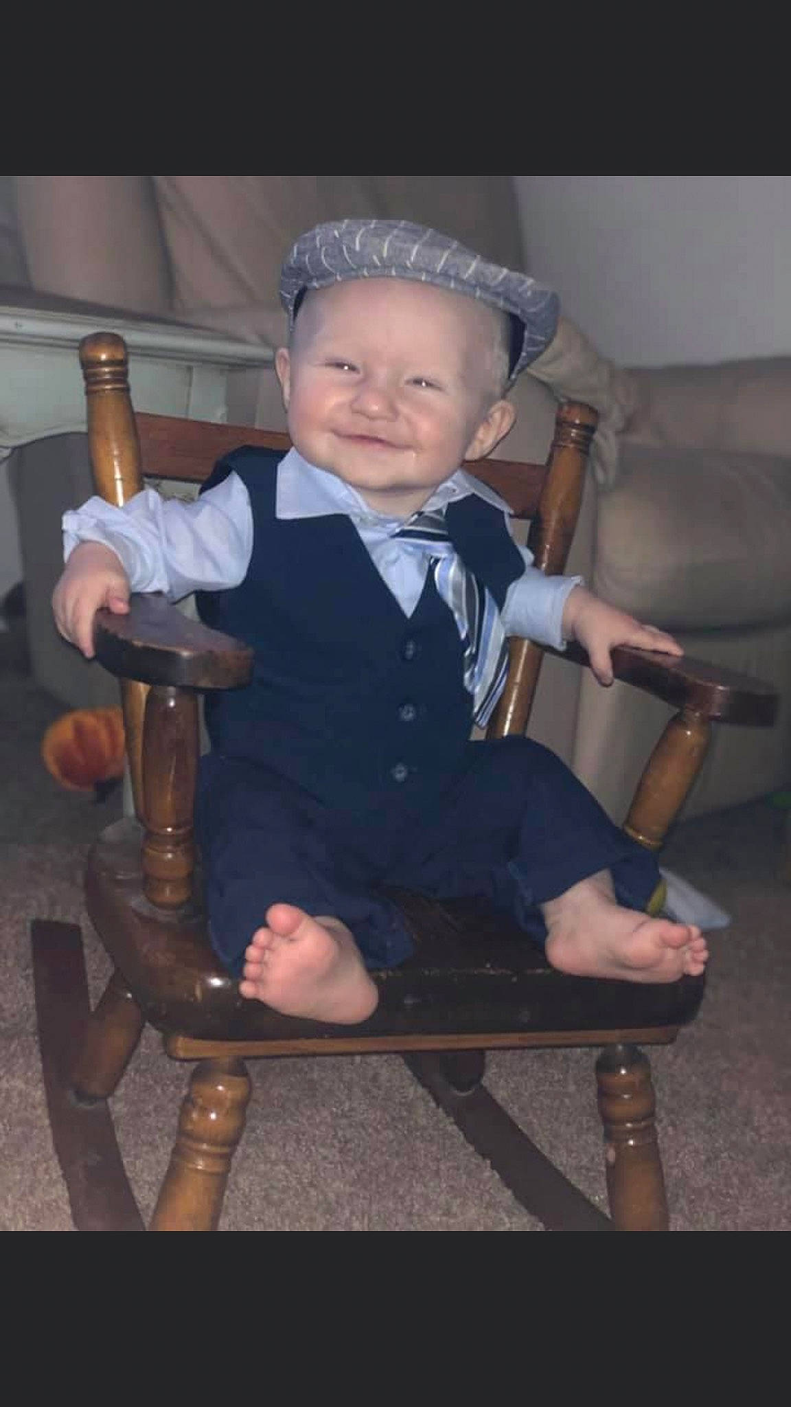 Jacob is registered to the contest to win money with this photo: baby, baby_carriage, baby_products, baby_toddler_clothing, car_seat, chair, child, flash_photography, formal_wear, fun, hat, human_leg, joy, knee, person, room, sitting, smile, suit, thumb