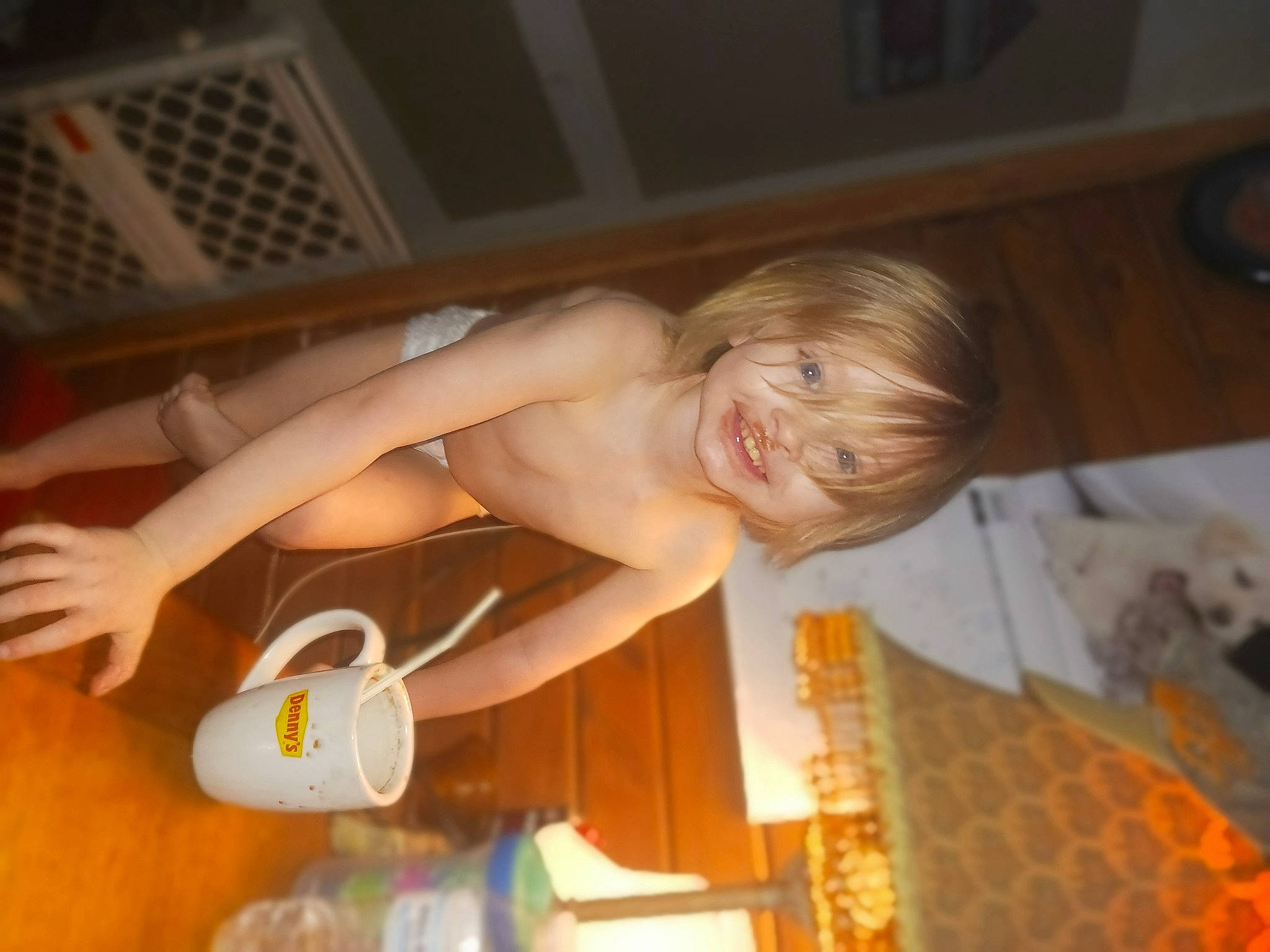 Daniel is registered to the contest to win money with this photo: abdomen, barechested, bathing, chest, child, elbow, flesh, flooring, fun, hardwood, human_leg, joy, leg, person, room, smile, thigh, thumb, toddler, trunk