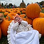 Danni-Rae is registered to the contest to win money with this photo: baby, blanket, pumpkin, pumpkin_patch, autumn, outdoor, grass, cloudy_sky, people, hay_bale, orange, headband, cute, child, fall, nature, seasonal, festive, smiling, cozy